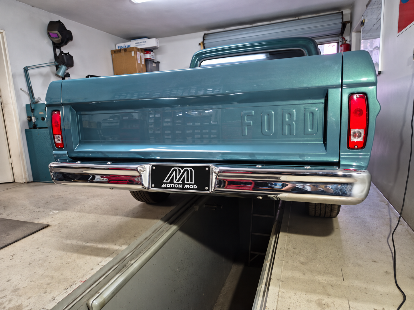 Straight-on rear view of the Ford F100 with Motion Mod plate in the workshop